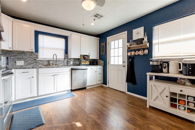 kitchen featuring white cabinets, dishwasher, range, and sink