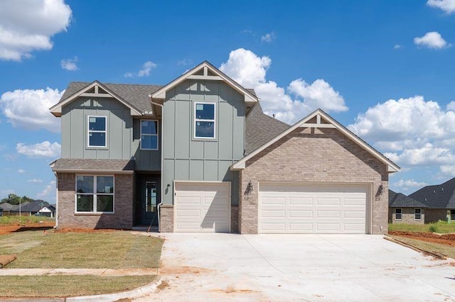 craftsman-style home featuring a garage and a front lawn