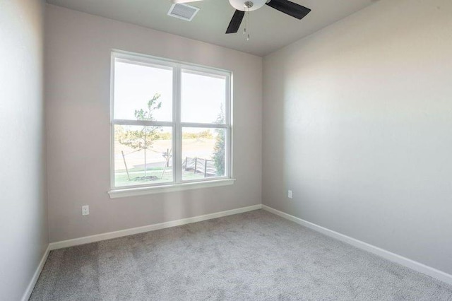 carpeted spare room featuring ceiling fan