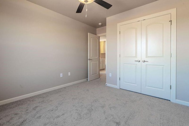 unfurnished bedroom with light carpet, a closet, and ceiling fan