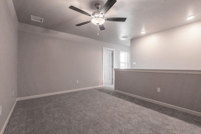 spare room with carpet and ceiling fan