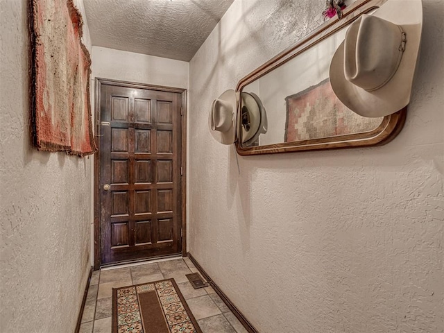 doorway featuring a textured ceiling