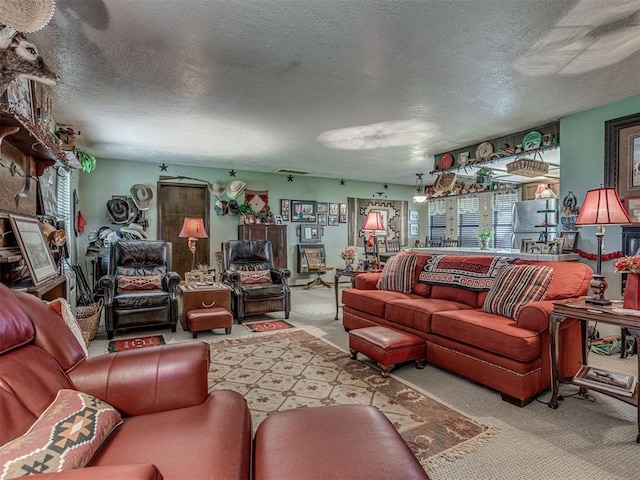 carpeted living room featuring a textured ceiling