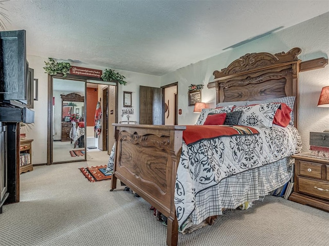 bedroom featuring a textured ceiling, light colored carpet, and a closet