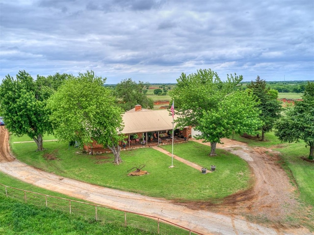 view of community with a rural view and a yard