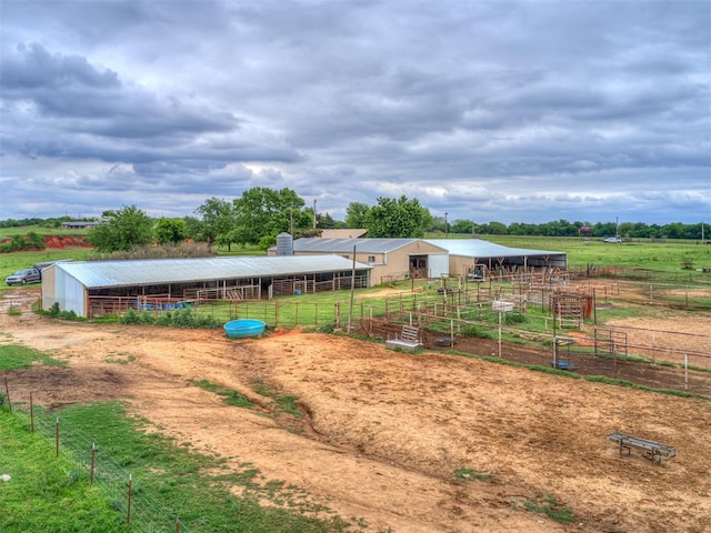 view of yard featuring a rural view and an outdoor structure