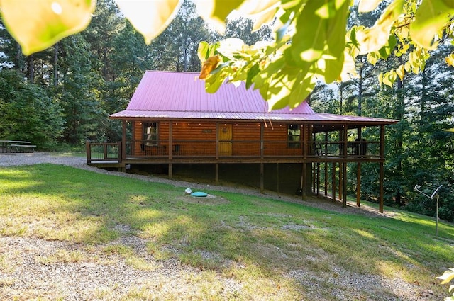 view of side of home with a lawn and a wooden deck