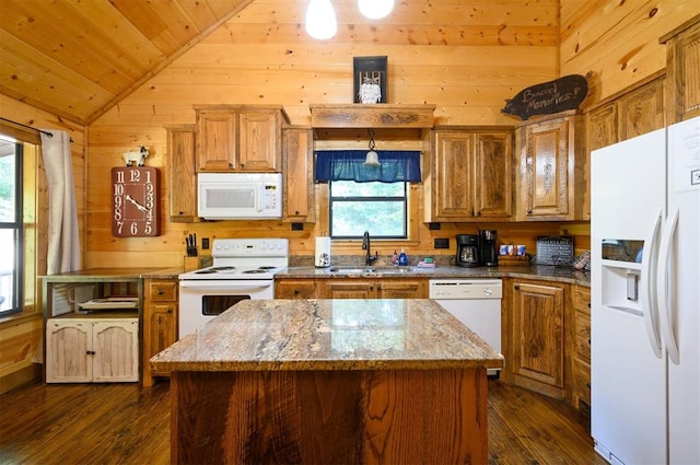 kitchen with white appliances, vaulted ceiling, a healthy amount of sunlight, and sink