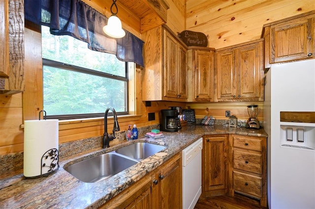 kitchen with a wealth of natural light, sink, hanging light fixtures, and white appliances