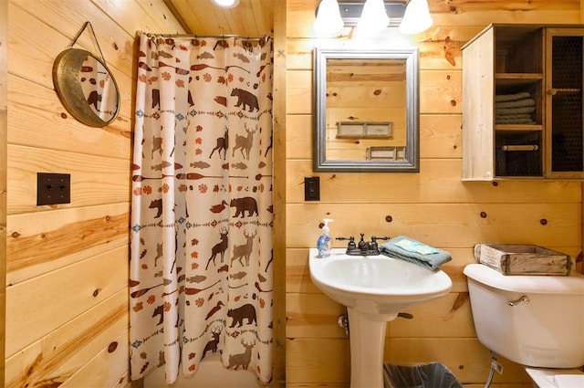 bathroom with wooden walls and toilet