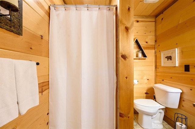 bathroom featuring wooden walls, wood ceiling, and toilet