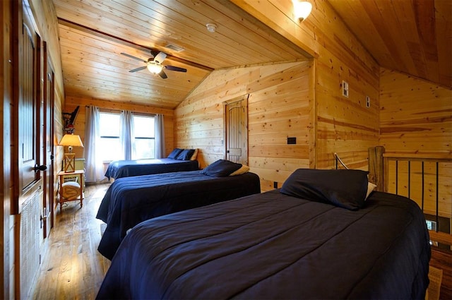 bedroom with ceiling fan, wooden ceiling, hardwood / wood-style floors, lofted ceiling, and wooden walls