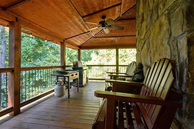 deck with area for grilling and ceiling fan