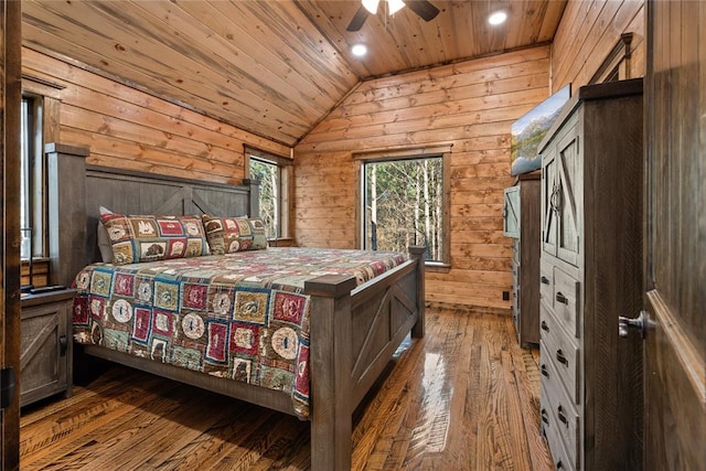 bedroom with wooden ceiling, wooden walls, vaulted ceiling, hardwood / wood-style flooring, and ceiling fan