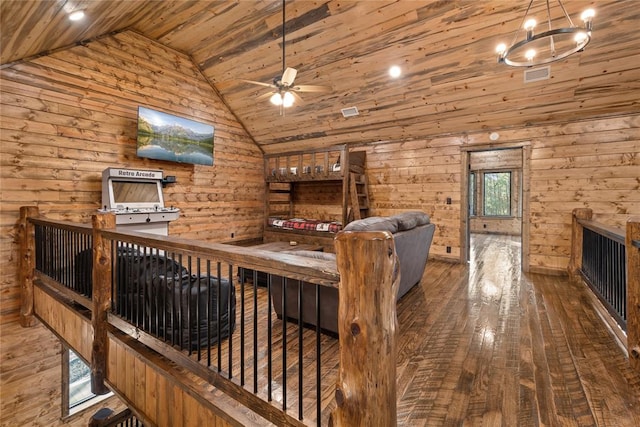 living room with wood walls, wooden ceiling, ceiling fan with notable chandelier, vaulted ceiling, and wood-type flooring