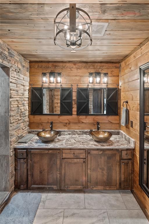 bathroom featuring vanity, wooden walls, a chandelier, and wooden ceiling