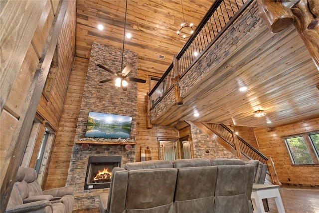 unfurnished living room with wooden ceiling, high vaulted ceiling, dark hardwood / wood-style floors, ceiling fan, and a fireplace