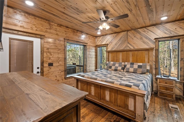 bedroom featuring wood walls and dark wood-type flooring