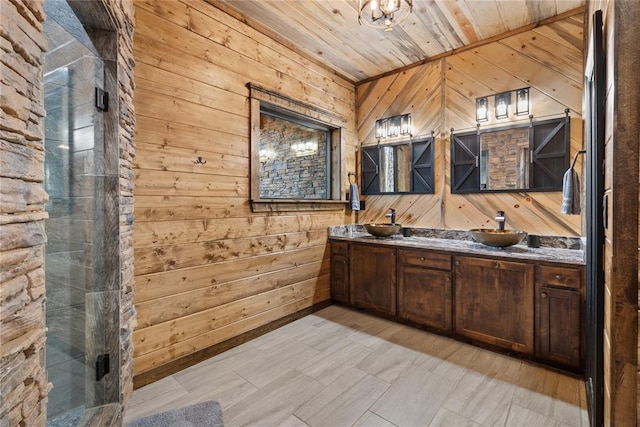 bathroom with vanity, a shower with door, wooden ceiling, and wood walls