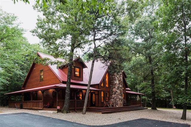 back of property with covered porch