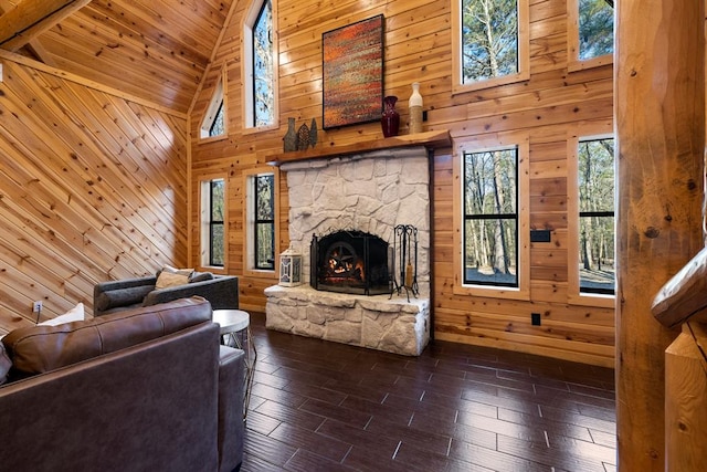 living room featuring dark hardwood / wood-style flooring, high vaulted ceiling, and wooden walls