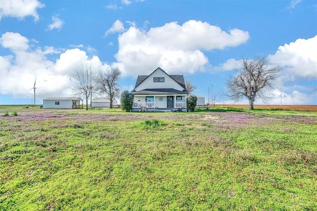 view of front of property with a porch and a rural view