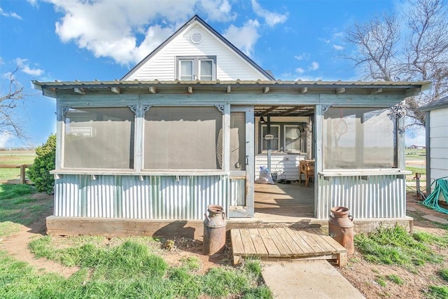 back of house with a sunroom