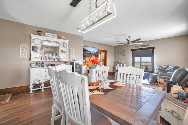 dining room with dark hardwood / wood-style floors and ceiling fan