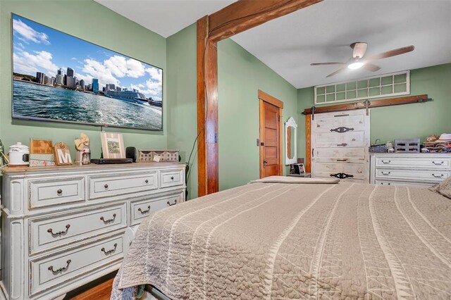 bedroom with hardwood / wood-style floors and ceiling fan