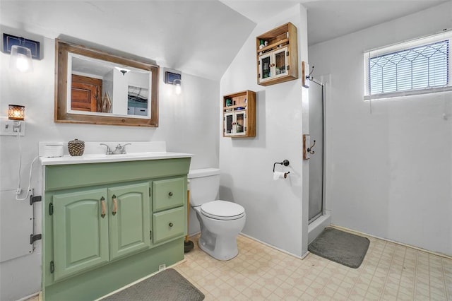 bathroom with vanity, toilet, a shower with shower door, and lofted ceiling