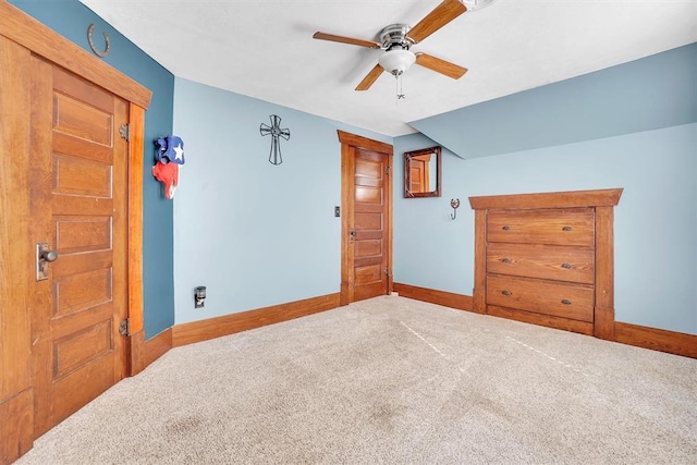 unfurnished bedroom with carpet flooring, vaulted ceiling, and ceiling fan