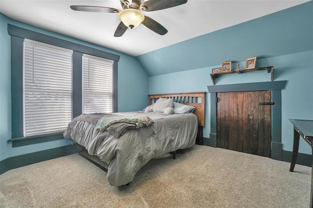 bedroom with carpet, vaulted ceiling, and ceiling fan