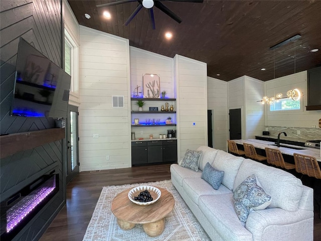 living room with ceiling fan, dark hardwood / wood-style flooring, wooden ceiling, and lofted ceiling