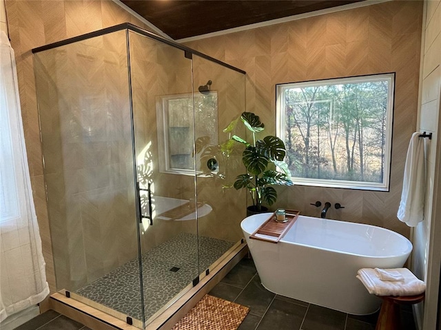 bathroom featuring tile patterned floors and independent shower and bath