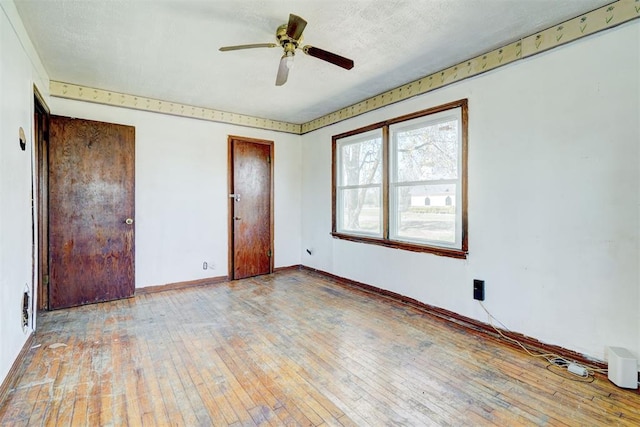 unfurnished bedroom featuring light hardwood / wood-style flooring and ceiling fan