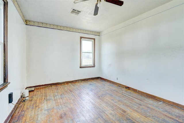 spare room featuring wood-type flooring and ceiling fan