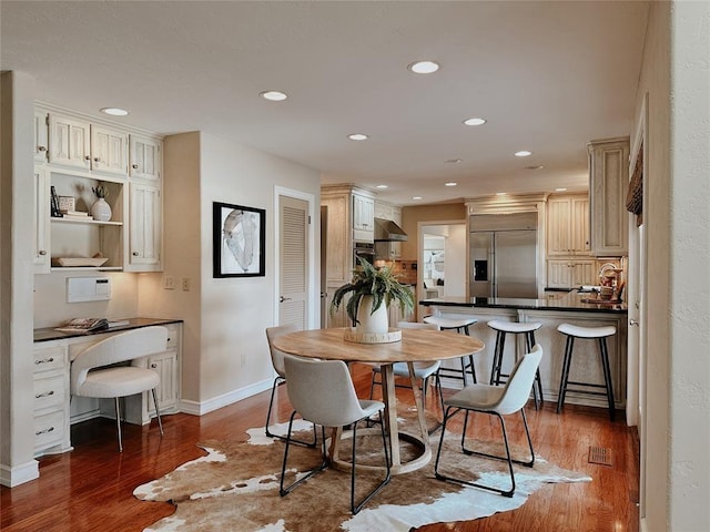 dining area with dark hardwood / wood-style floors