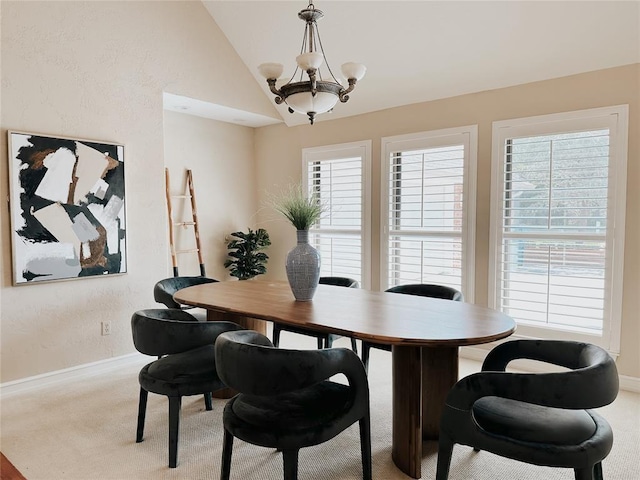 carpeted dining area featuring vaulted ceiling and a notable chandelier