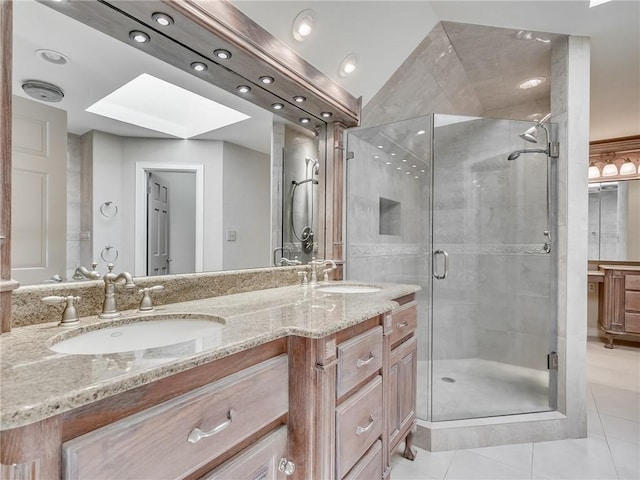 bathroom featuring tile patterned flooring, vanity, an enclosed shower, and a skylight