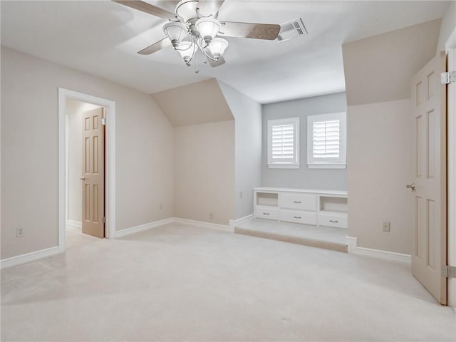 additional living space featuring light carpet, ceiling fan, and lofted ceiling