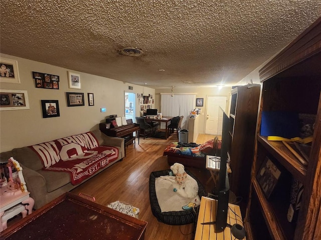 living room with hardwood / wood-style floors and a textured ceiling