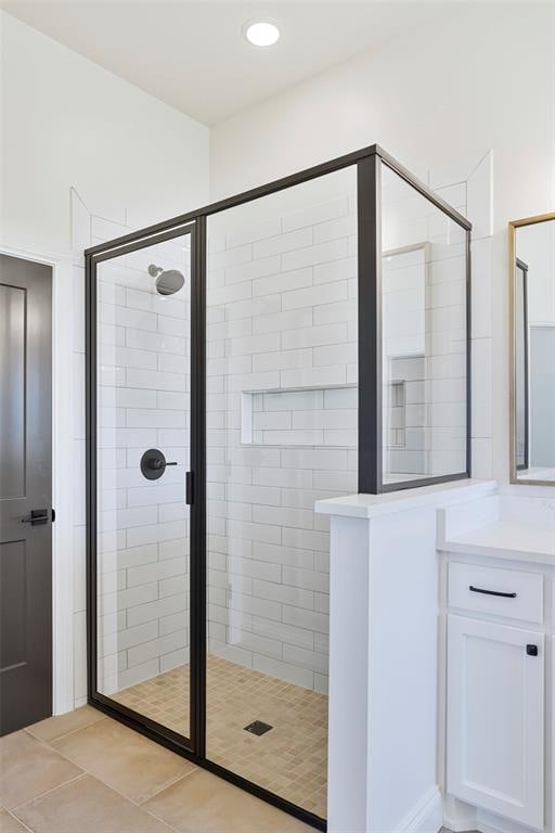 bathroom featuring tile patterned floors, vanity, and walk in shower