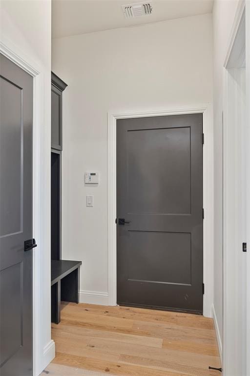 mudroom with wood-type flooring