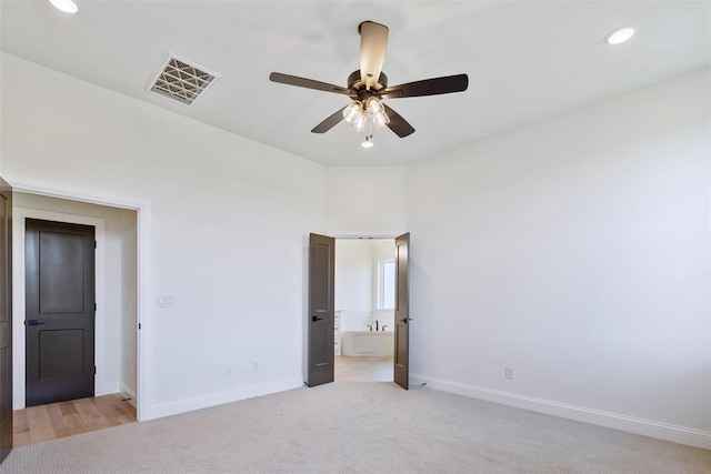 unfurnished bedroom with light carpet and ceiling fan