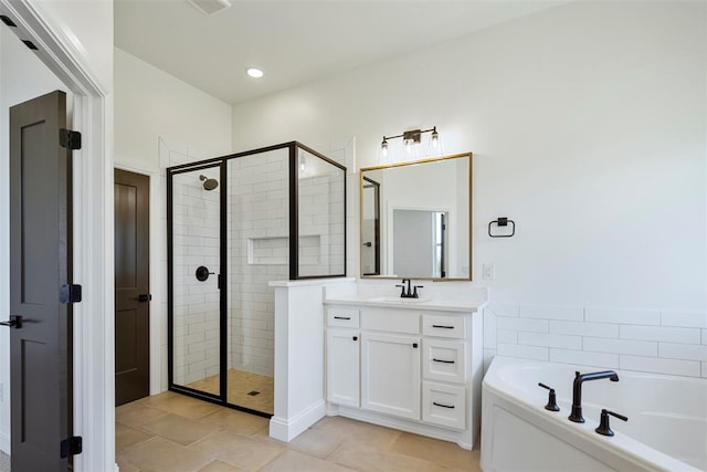 bathroom featuring tile patterned flooring, vanity, and separate shower and tub