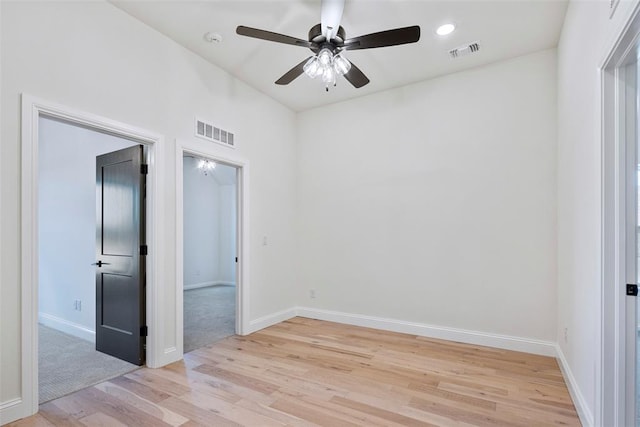 empty room with light hardwood / wood-style floors and ceiling fan