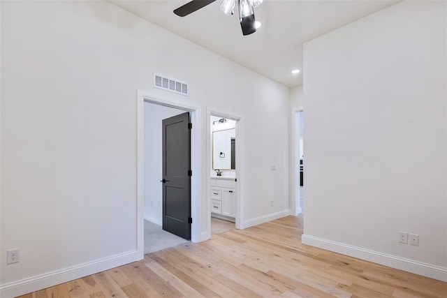 spare room featuring light wood-type flooring and ceiling fan