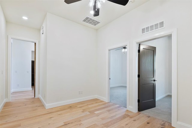 unfurnished room with ceiling fan and light hardwood / wood-style flooring