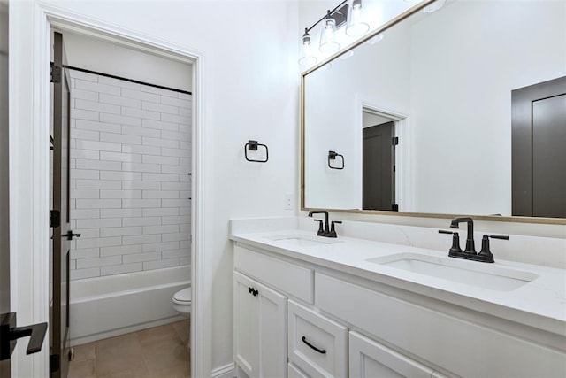 full bathroom with tile patterned flooring, vanity, toilet, and tiled shower / bath combo