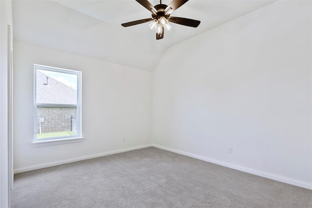 unfurnished room with ceiling fan, light colored carpet, and lofted ceiling